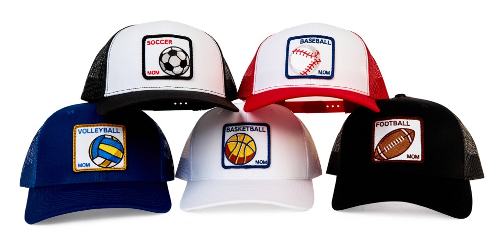 All five game day collection hats. Top row left to right Soccer and Baseball. Bottom Row left to Right Volleyball, Basketball, Football
